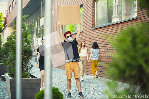 Image of Dude with sign - man stands protesting things that annoy him