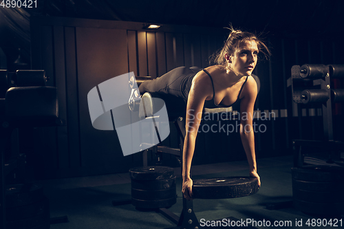 Image of The female athlete training hard in the gym. Fitness and healthy life concept.
