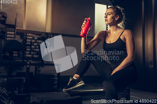 Image of The female athlete training hard in the gym. Fitness and healthy life concept.