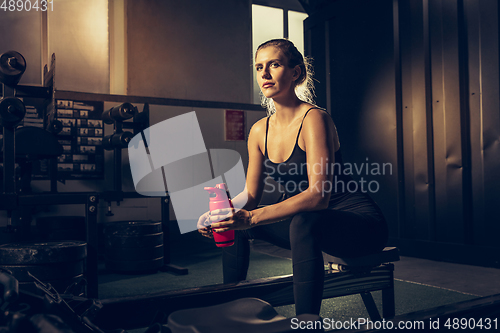 Image of The female athlete training hard in the gym. Fitness and healthy life concept.