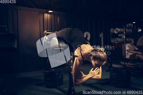 Image of The female athlete training hard in the gym. Fitness and healthy life concept.