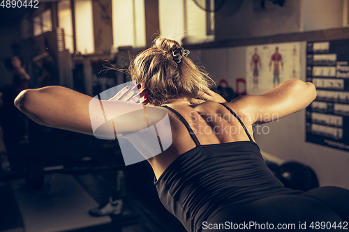 Image of The female athlete training hard in the gym. Fitness and healthy life concept.