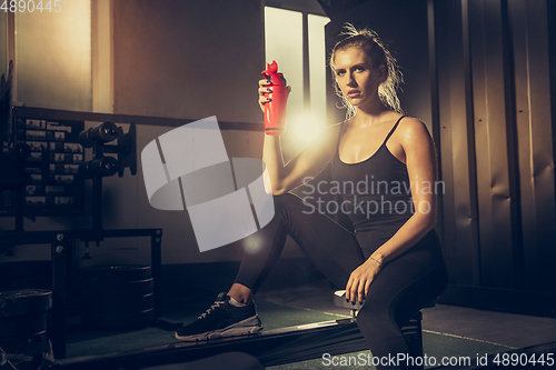 Image of The female athlete training hard in the gym. Fitness and healthy life concept.