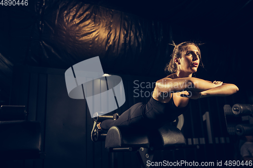Image of The female athlete training hard in the gym. Fitness and healthy life concept.