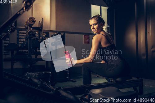 Image of The female athlete training hard in the gym. Fitness and healthy life concept.