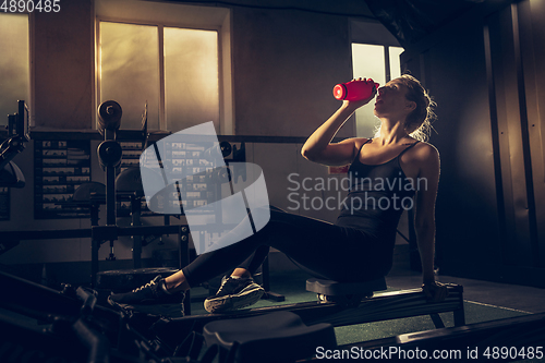 Image of The female athlete training hard in the gym. Fitness and healthy life concept.