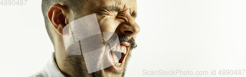 Image of Caucasian young man\'s close up cropped shot on studio background, flyer