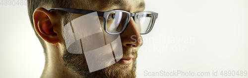 Image of Caucasian young man\'s close up cropped shot on studio background, flyer