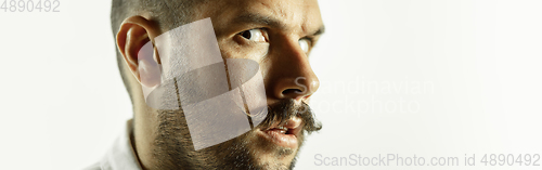 Image of Caucasian young man\'s close up cropped shot on studio background, flyer