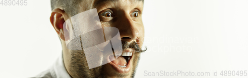 Image of Caucasian young man\'s close up cropped shot on studio background, flyer