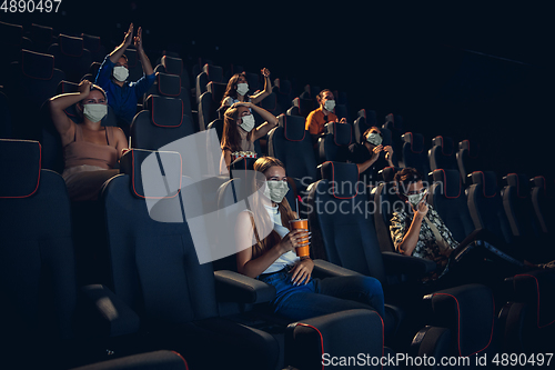 Image of Cinema, movie theatre during quarantine. Coronavirus pandemic safety rules, social distance during movie watching