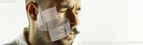Image of Caucasian young man\'s close up cropped shot on studio background, flyer