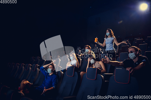 Image of Cinema, movie theatre during quarantine. Coronavirus pandemic safety rules, social distance during movie watching