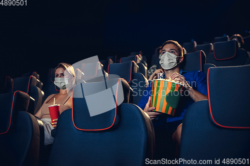 Image of Cinema, movie theatre during quarantine. Coronavirus pandemic safety rules, social distance during movie watching