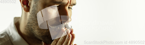 Image of Caucasian young man\'s close up cropped shot on studio background, flyer