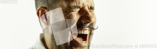 Image of Caucasian young man\'s close up cropped shot on studio background, flyer