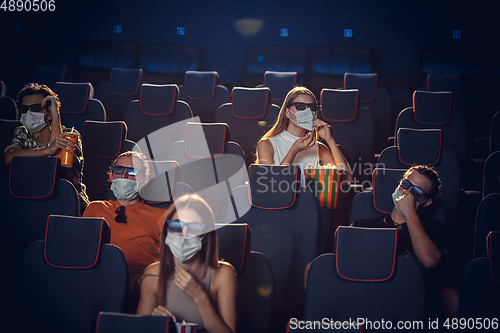 Image of Cinema, movie theatre during quarantine. Coronavirus pandemic safety rules, social distance during movie watching