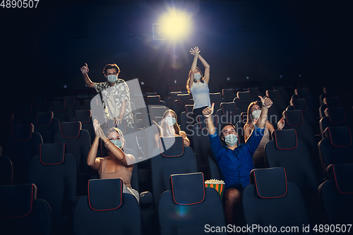 Image of Cinema, movie theatre during quarantine. Coronavirus pandemic safety rules, social distance during movie watching