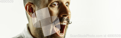Image of Caucasian young man\'s close up cropped shot on studio background, flyer