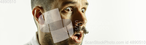 Image of Caucasian young man\'s close up cropped shot on studio background, flyer
