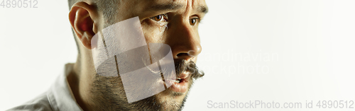 Image of Caucasian young man\'s close up cropped shot on studio background, flyer