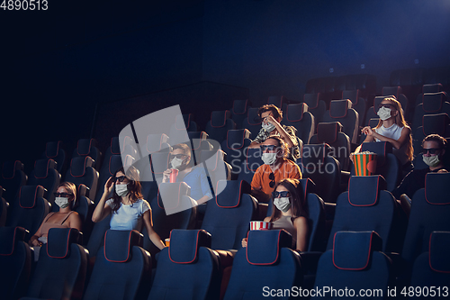 Image of Cinema, movie theatre during quarantine. Coronavirus pandemic safety rules, social distance during movie watching