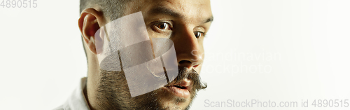 Image of Caucasian young man\'s close up cropped shot on studio background, flyer