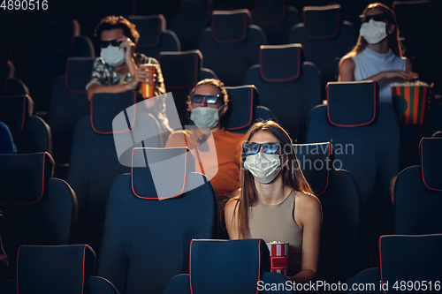 Image of Cinema, movie theatre during quarantine. Coronavirus pandemic safety rules, social distance during movie watching