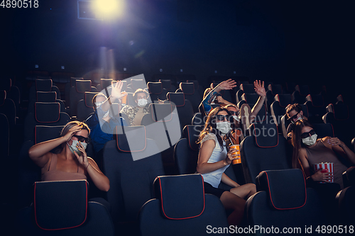 Image of Cinema, movie theatre during quarantine. Coronavirus pandemic safety rules, social distance during movie watching