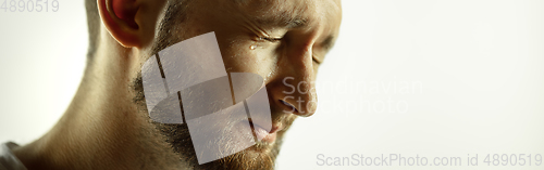 Image of Caucasian young man\'s close up cropped shot on studio background, flyer