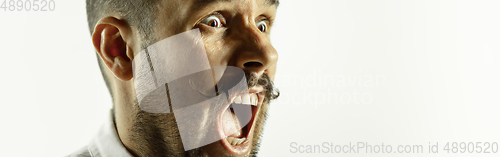 Image of Caucasian young man\'s close up cropped shot on studio background, flyer