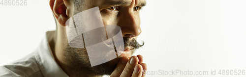 Image of Caucasian young man\'s close up cropped shot on studio background, flyer
