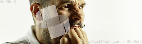 Image of Caucasian young man\'s close up cropped shot on studio background, flyer