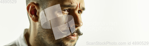 Image of Caucasian young man\'s close up cropped shot on studio background, flyer