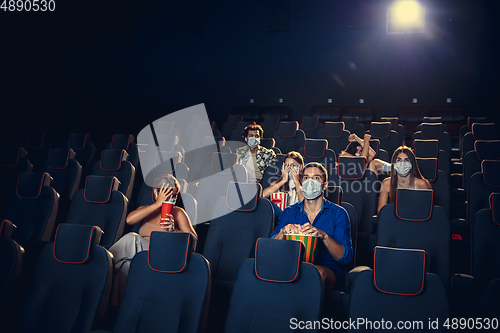 Image of Cinema, movie theatre during quarantine. Coronavirus pandemic safety rules, social distance during movie watching