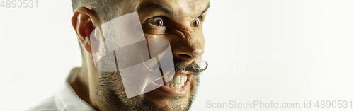 Image of Caucasian young man\'s close up cropped shot on studio background, flyer
