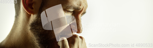 Image of Caucasian young man\'s close up cropped shot on studio background, flyer