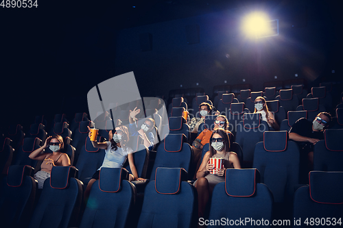 Image of Cinema, movie theatre during quarantine. Coronavirus pandemic safety rules, social distance during movie watching