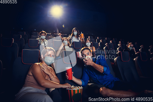 Image of Cinema, movie theatre during quarantine. Coronavirus pandemic safety rules, social distance during movie watching