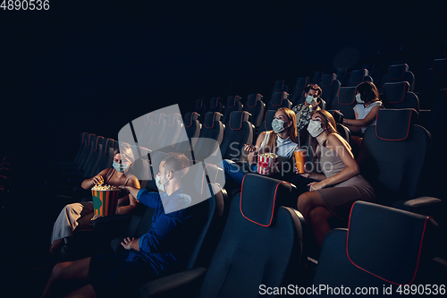 Image of Cinema, movie theatre during quarantine. Coronavirus pandemic safety rules, social distance during movie watching