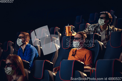 Image of Cinema, movie theatre during quarantine. Coronavirus pandemic safety rules, social distance during movie watching