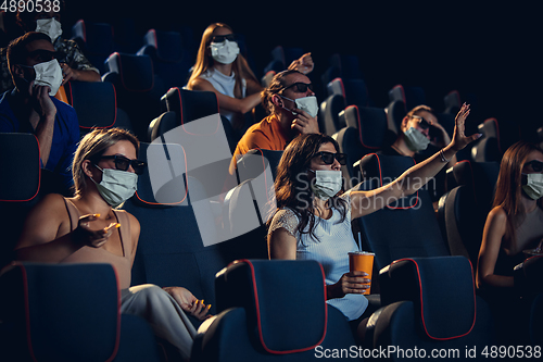 Image of Cinema, movie theatre during quarantine. Coronavirus pandemic safety rules, social distance during movie watching