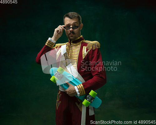 Image of Young man as Nicholas II on dark green background. Retro style, comparison of eras concept.