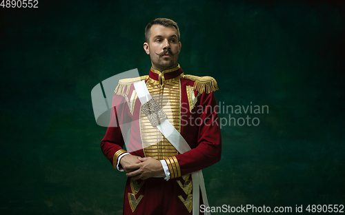 Image of Young man as Nicholas II on dark green background. Retro style, comparison of eras concept.