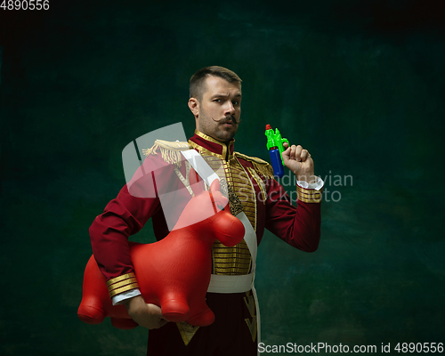 Image of Young man as Nicholas II on dark green background. Retro style, comparison of eras concept.