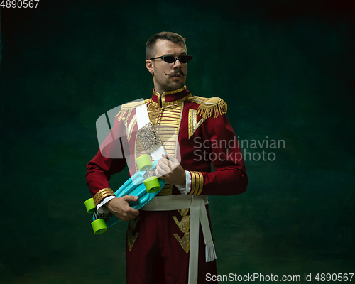 Image of Young man as Nicholas II on dark green background. Retro style, comparison of eras concept.