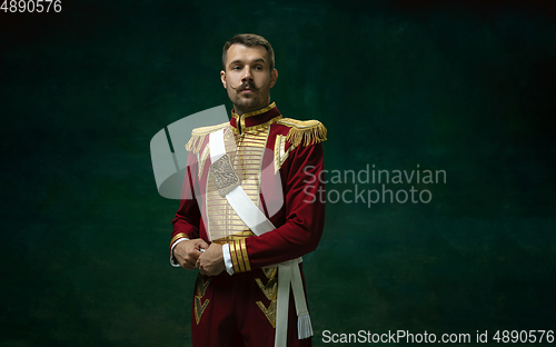 Image of Young man as Nicholas II on dark green background. Retro style, comparison of eras concept.