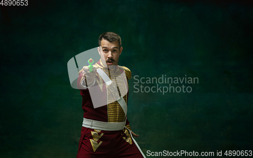 Image of Young man as Nicholas II on dark green background. Retro style, comparison of eras concept.