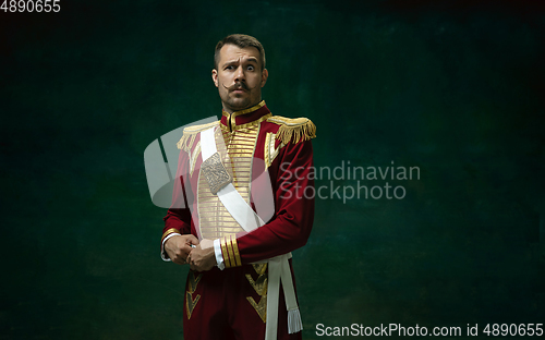 Image of Young man as Nicholas II on dark green background. Retro style, comparison of eras concept.