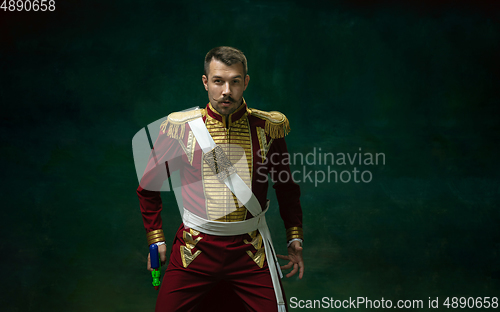 Image of Young man as Nicholas II on dark green background. Retro style, comparison of eras concept.